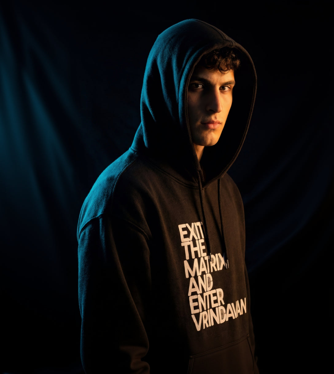 Person wearing a hoodie with text on a dark background