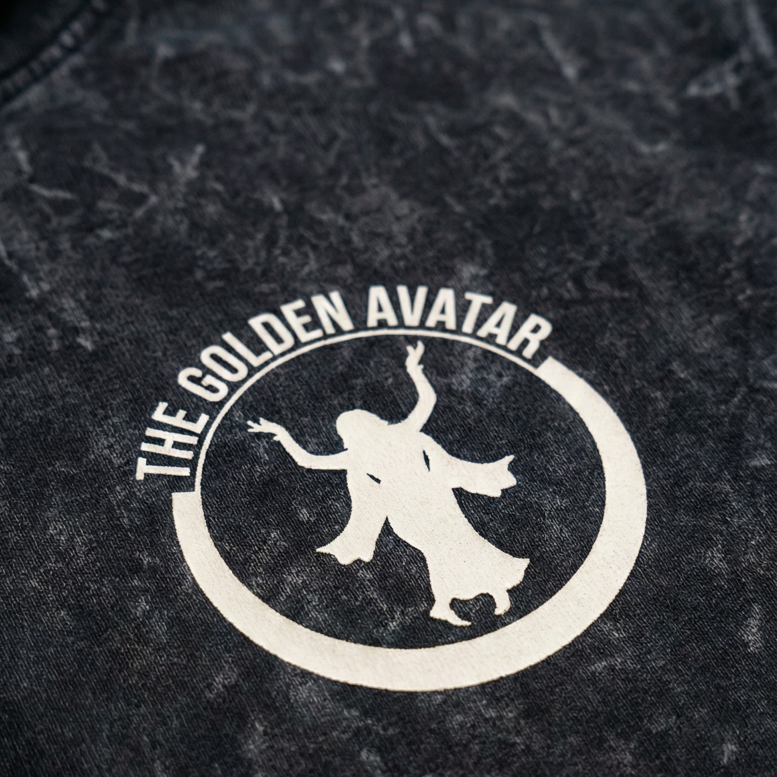 Black denim jacket with 'The Golden Avatar' logo on a dark background