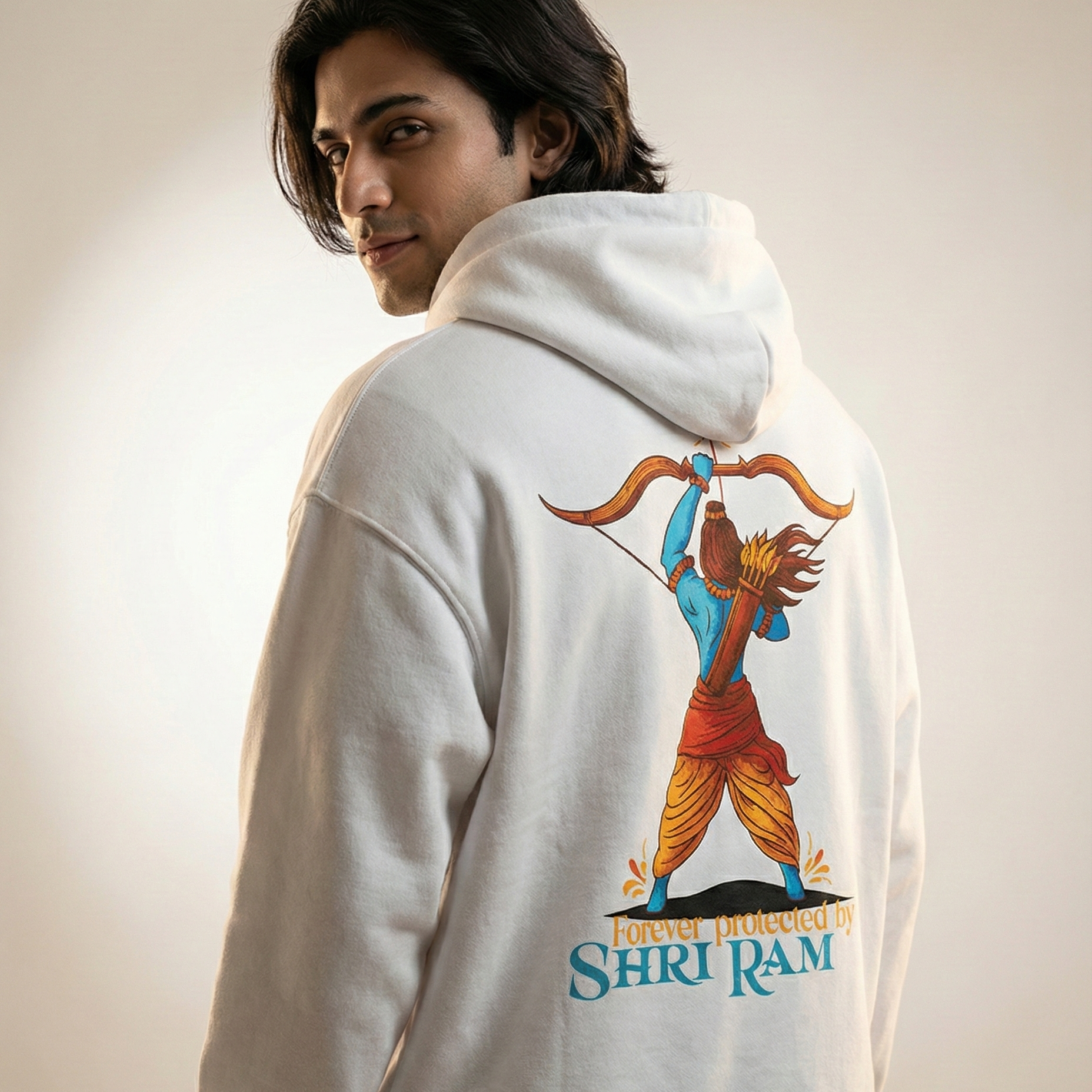 Person wearing a hoodie with a colorful graphic and text on the back against a plain background