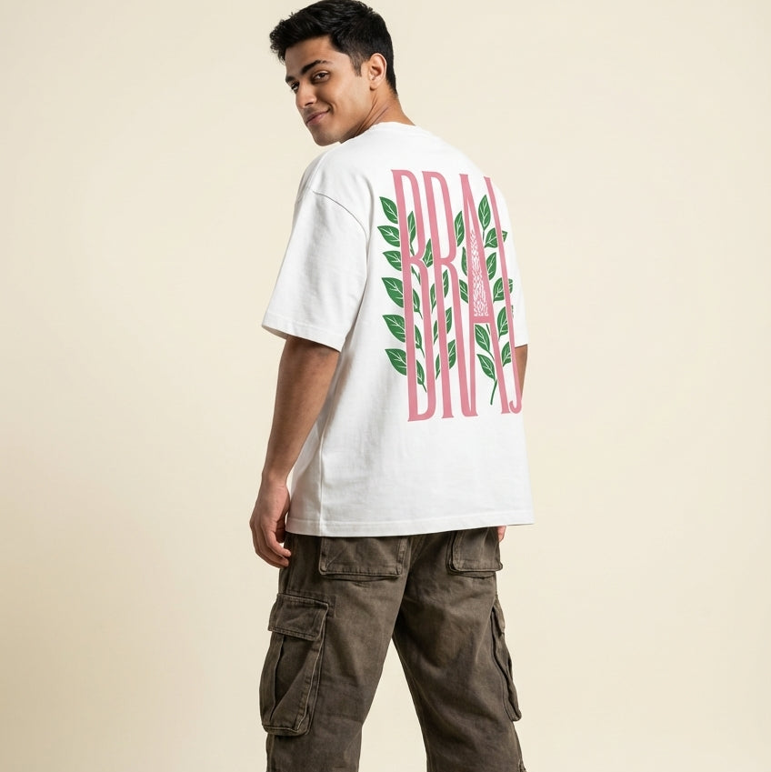 Person wearing a white t-shirt with a graphic design and cargo pants on a beige background