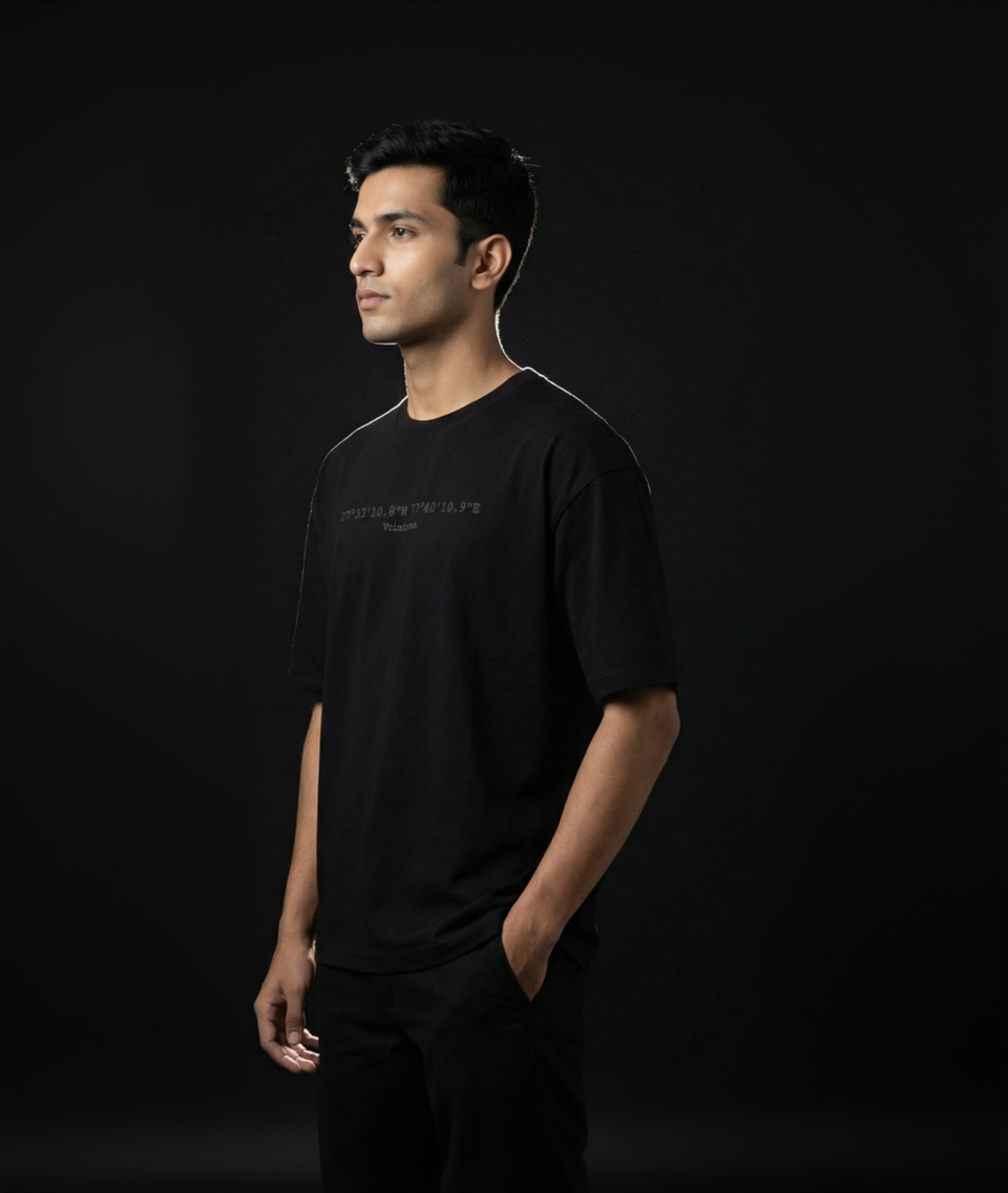 Man wearing a black t-shirt with text on a black background
