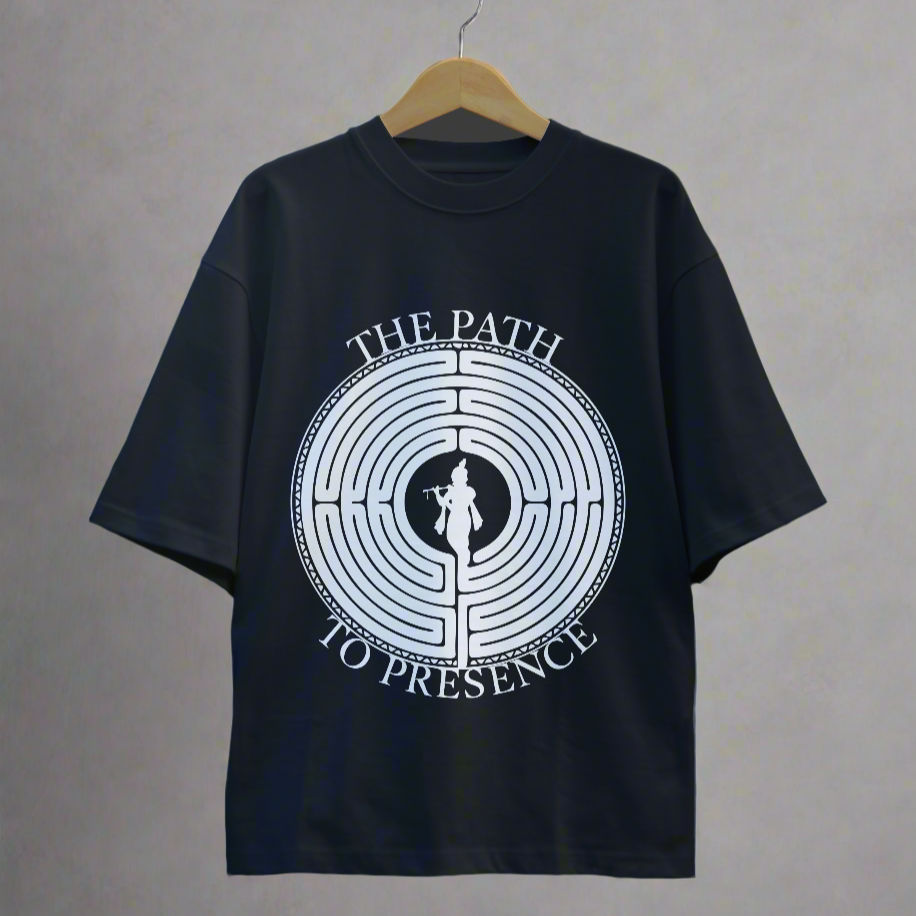 Navy blue t-shirt with white graphic design on a hanger against a dark background